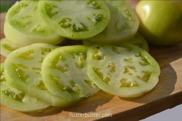 Fried Green Tomatoes - a simple, southern delicacy made from unripe tomatoes, dredged in a flour mixture and fried.  The slight sour flavor of the tomatoes works great with crunchy coating. 