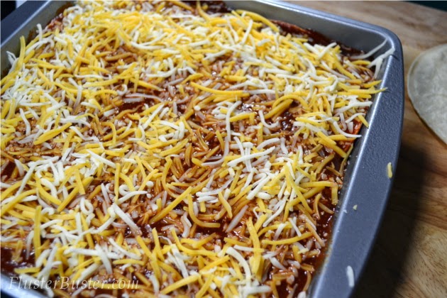 Simple Chicken Enchilada Casserole -  seasoned chicken, layered between corn tortillas and cheese and then covered a flavorful sauce.