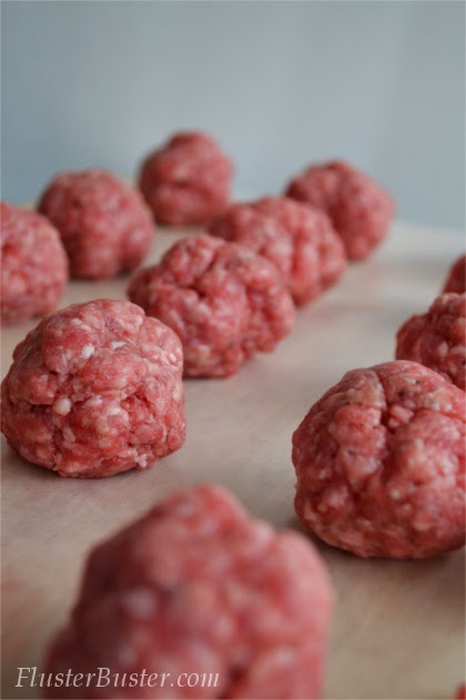 Simple Cheeseburger Sliders - Seasoned ground beef patties topped with cheddar cheese and served on a small sized bun.