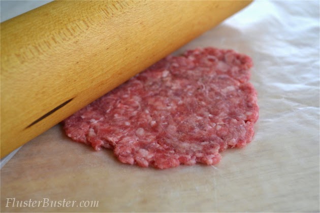 Simple Cheeseburger Sliders - Seasoned ground beef patties topped with cheddar cheese and served on a small sized bun.