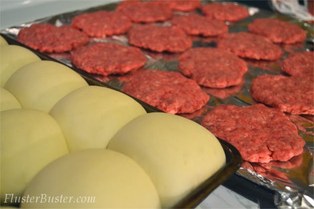 Simple Cheeseburger Sliders - Seasoned ground beef patties topped with cheddar cheese and served on a small sized bun.