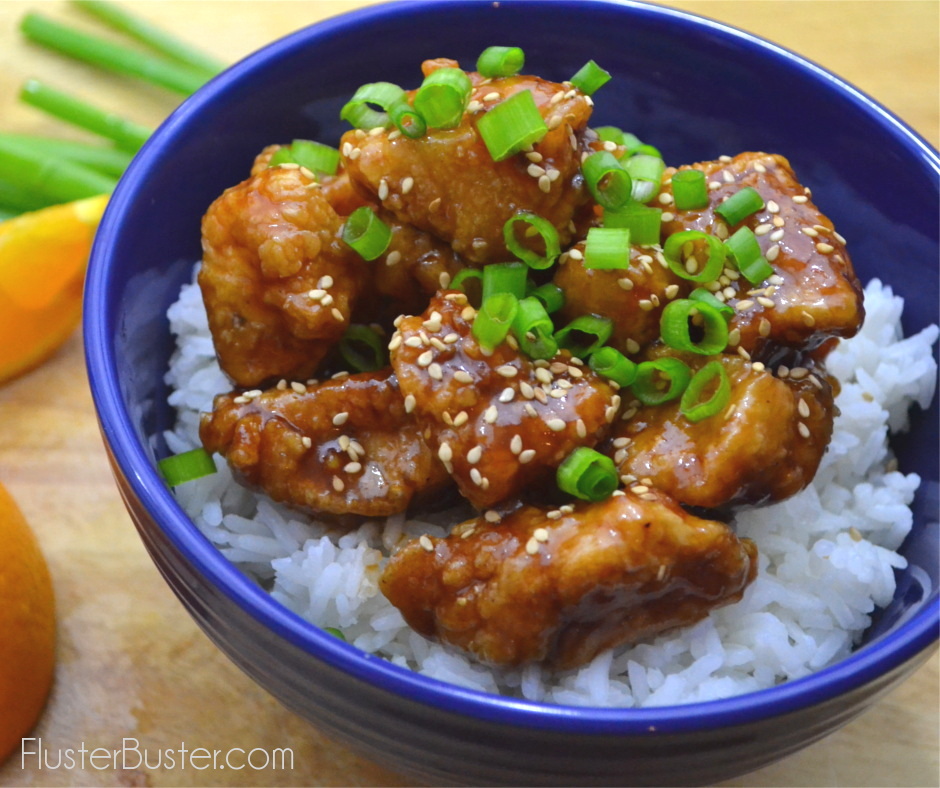 Classic Chinese Orange Chicken. This simple recipe is made with batter fried chicken coated with a sweet and tangy caramelized glaze. Serve over rice, top with sesame seeds and green onions for a classic takeout favorite.