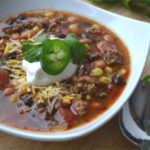This is how I beat the cold, with a nice warm bowl of Mexican Chili served with a handful of corn chips. It's simple, delcious and it will warm you from your head to your toes.