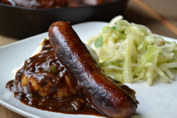 Simple Bangers and Mash - browned sausages served over mashed potatoes and covered in a savory onion gravy.